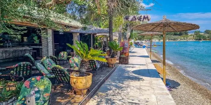 Dassia Beach in Corfu, Greece – pebble beach with calm Ionian Sea waters and green hills