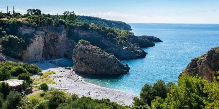 Foneas Beach in Greece with turquoise waters, pebble shore, and cliffs in West Mani, Peloponnese