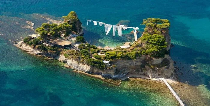 Laganas Beach Zakynthos with golden sandy shore, calm shallow water, and clear blue Ionian Sea