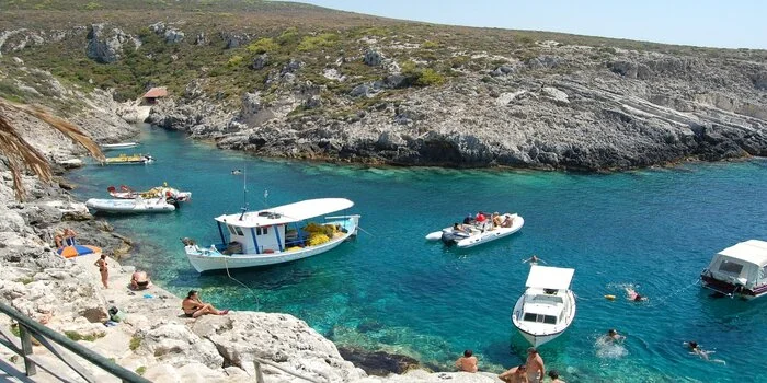 Porto Roxa Beach Zakynthos Greece, rocky cove with clear turquoise water and cliffs