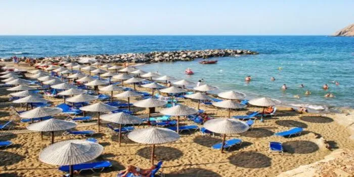 Rethymno Beach in Crete, Greece with golden sand, clear blue water, and calm Mediterranean shoreline