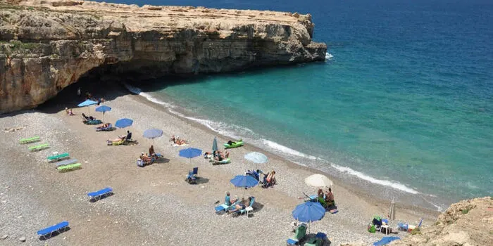 Spilies Beach Crete with clear turquoise water, pebbly shore, and cliffs near Rethymnon