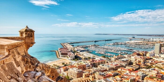 Things to do in Alicante showing the city beach, harbor, and Santa Bárbara Castle
